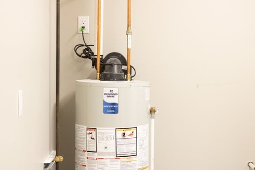 A Bradford White hot water tank connected in the utility room.
