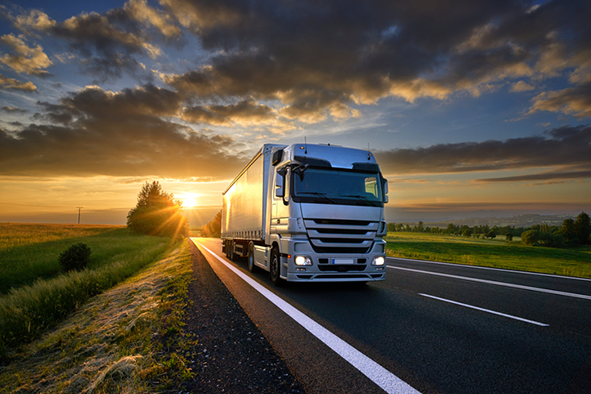 truck on a road at sunset