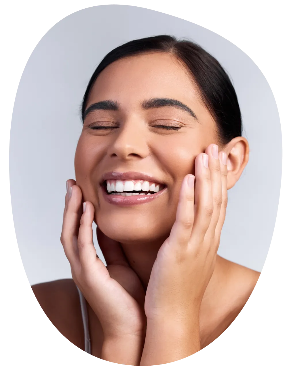 Three girls smiling together in front of purple background