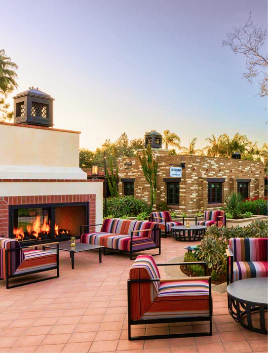 Outdoor patio lounge with fireplace at Estancia La Jolla