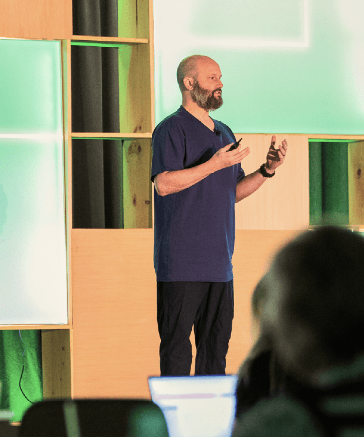 Speaker presenting to attendees at Happy Summit, representing the Owners & Executives track