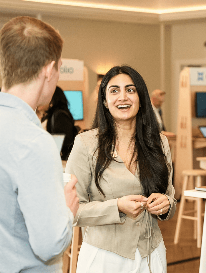Two Happy Summit attendees talking together at the event