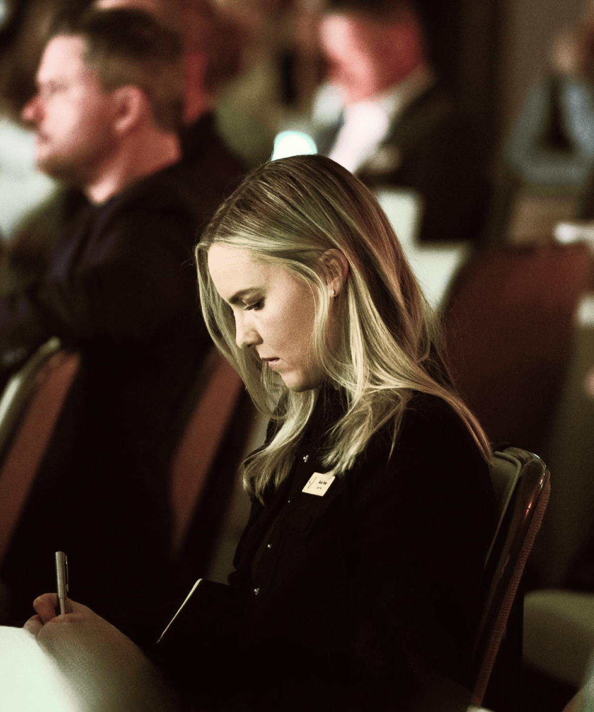 Attendee taking notes at Happy Summit, representing the Procurement Pros track