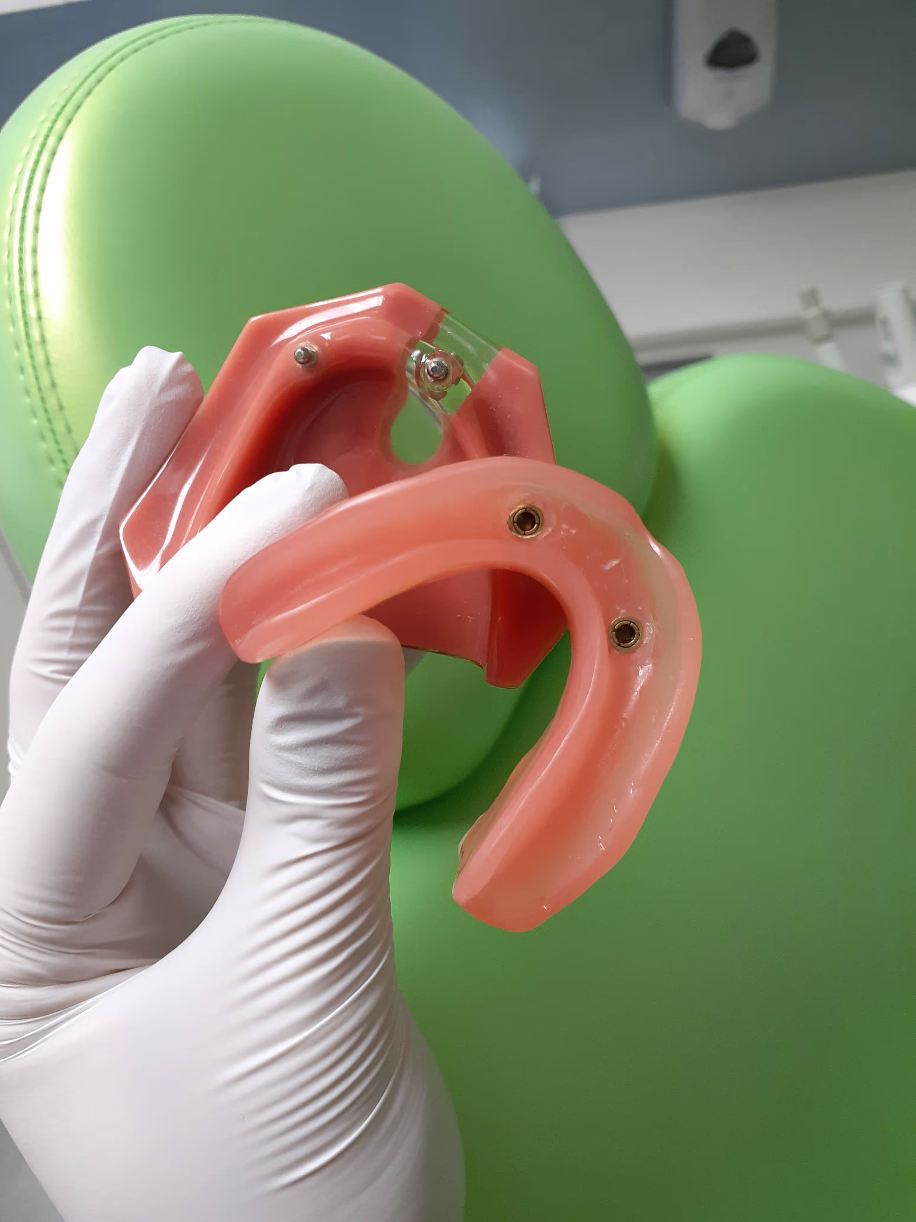 Implant supported dentures being held by dentist