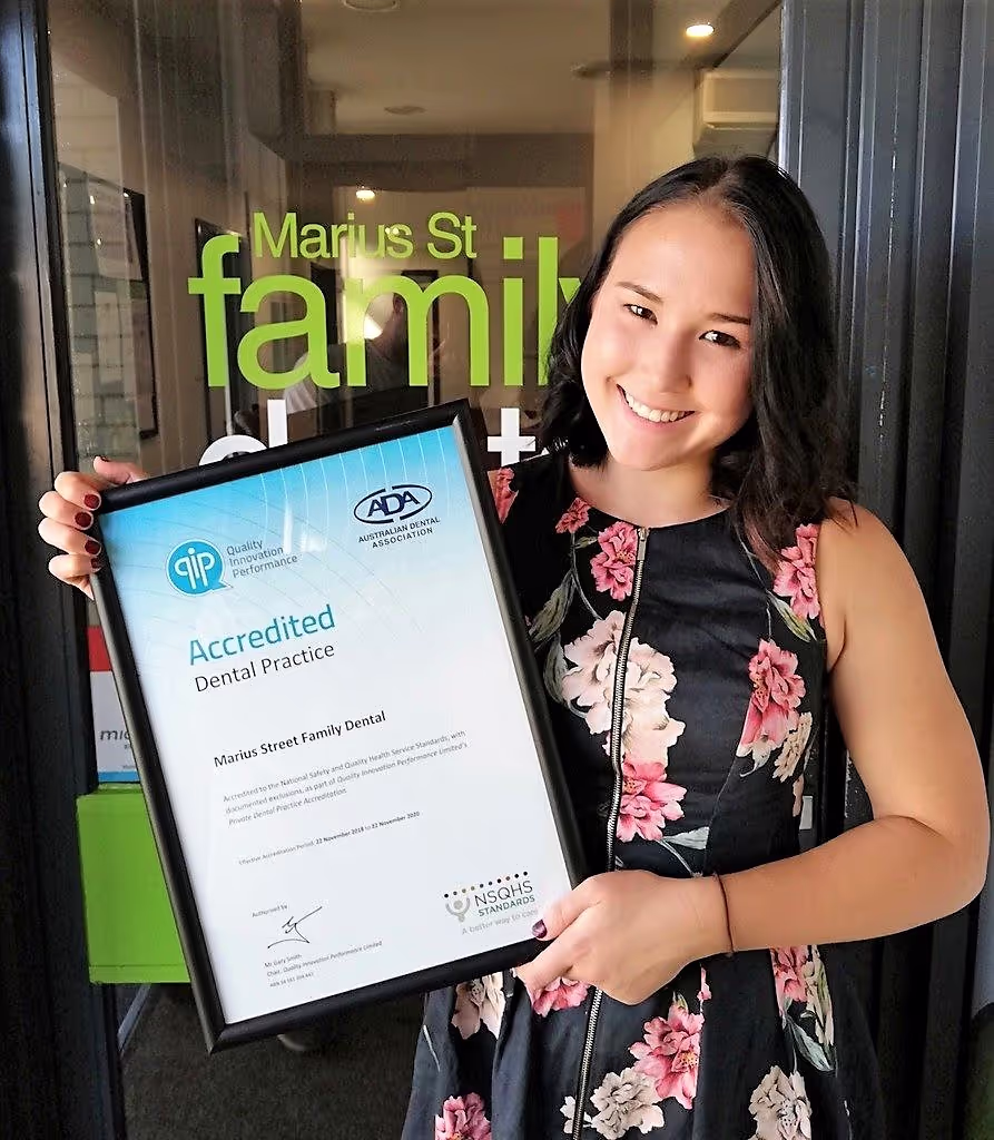 Vera holding an accreditation certificate