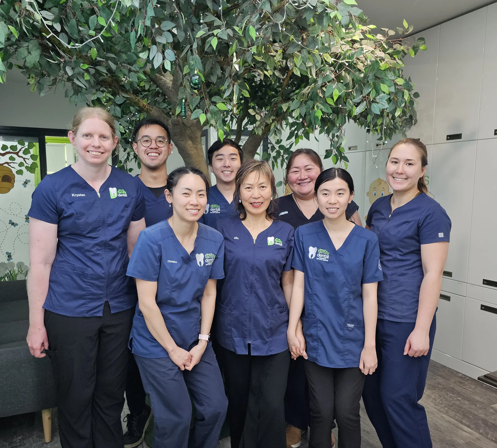 A group of dentists from Marius St Family Dental standing in front of a tree