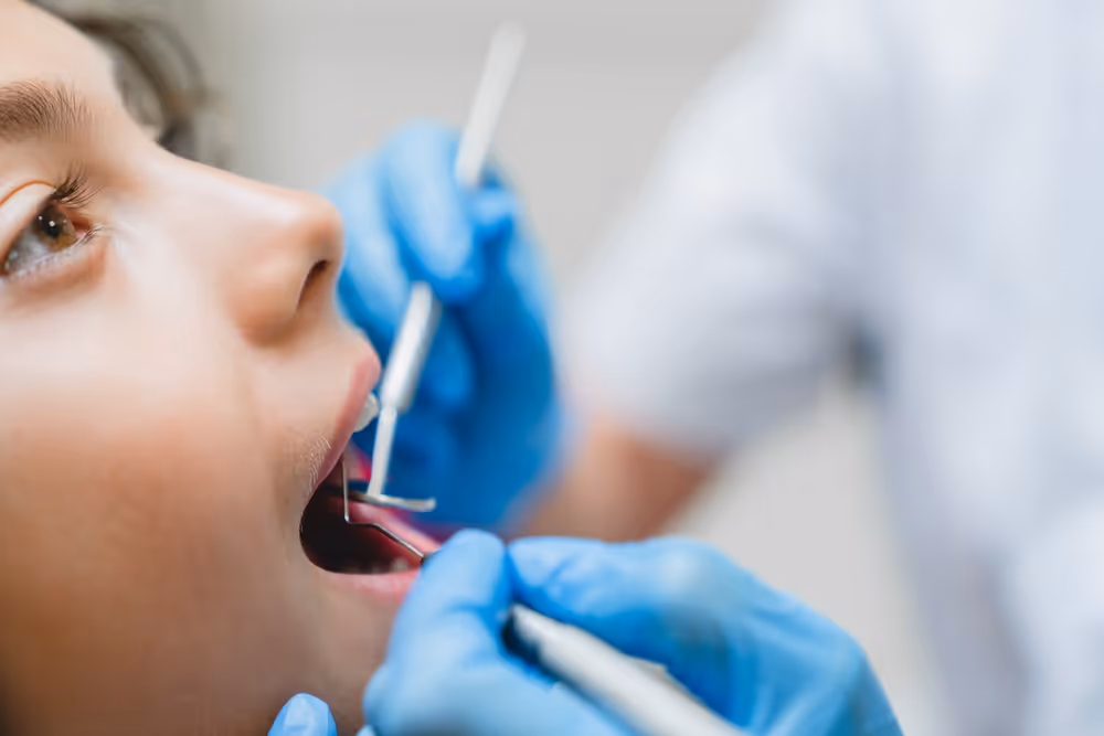 Child getting dental examination by dentist