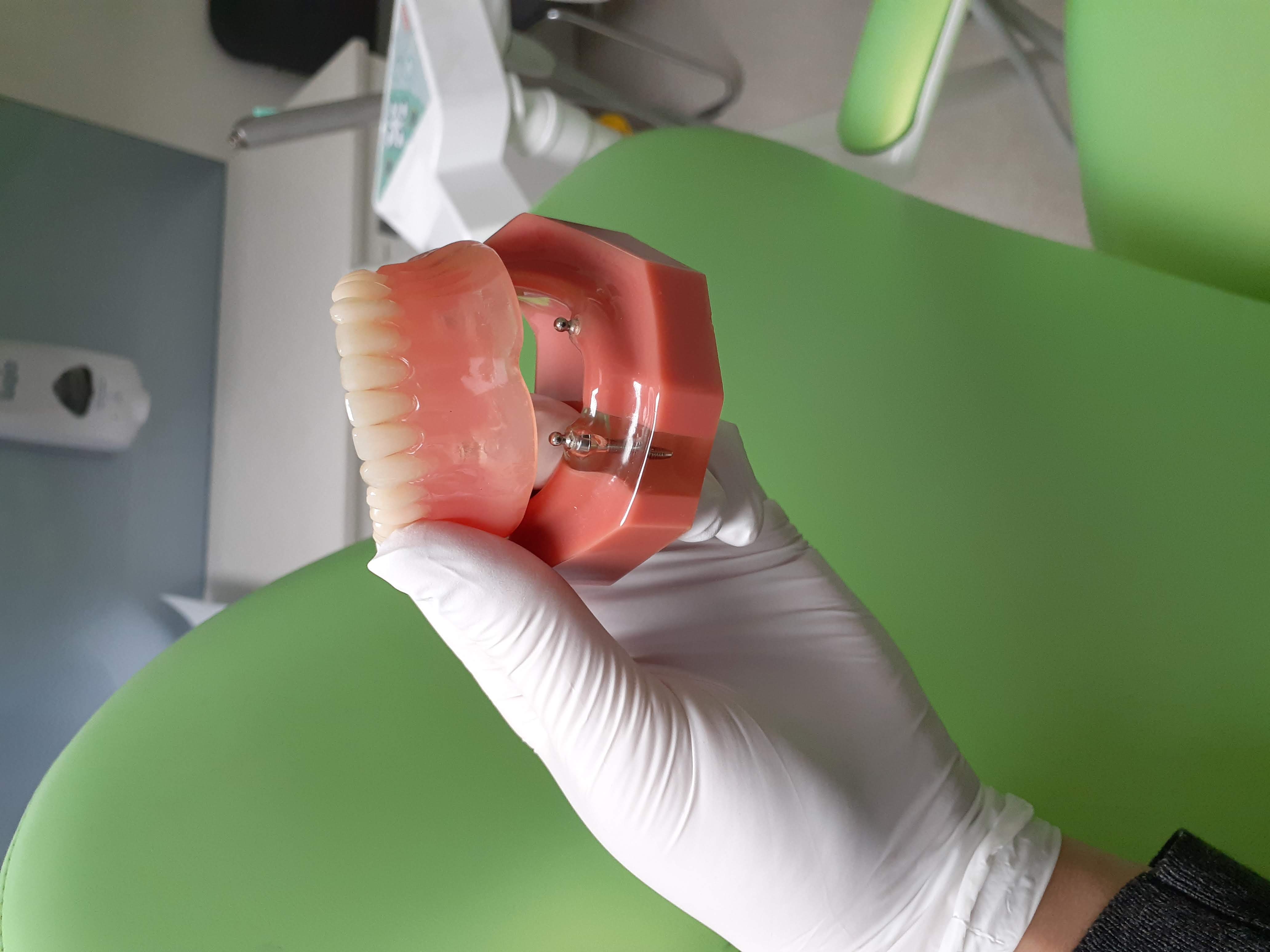 Dentures being held by dentist