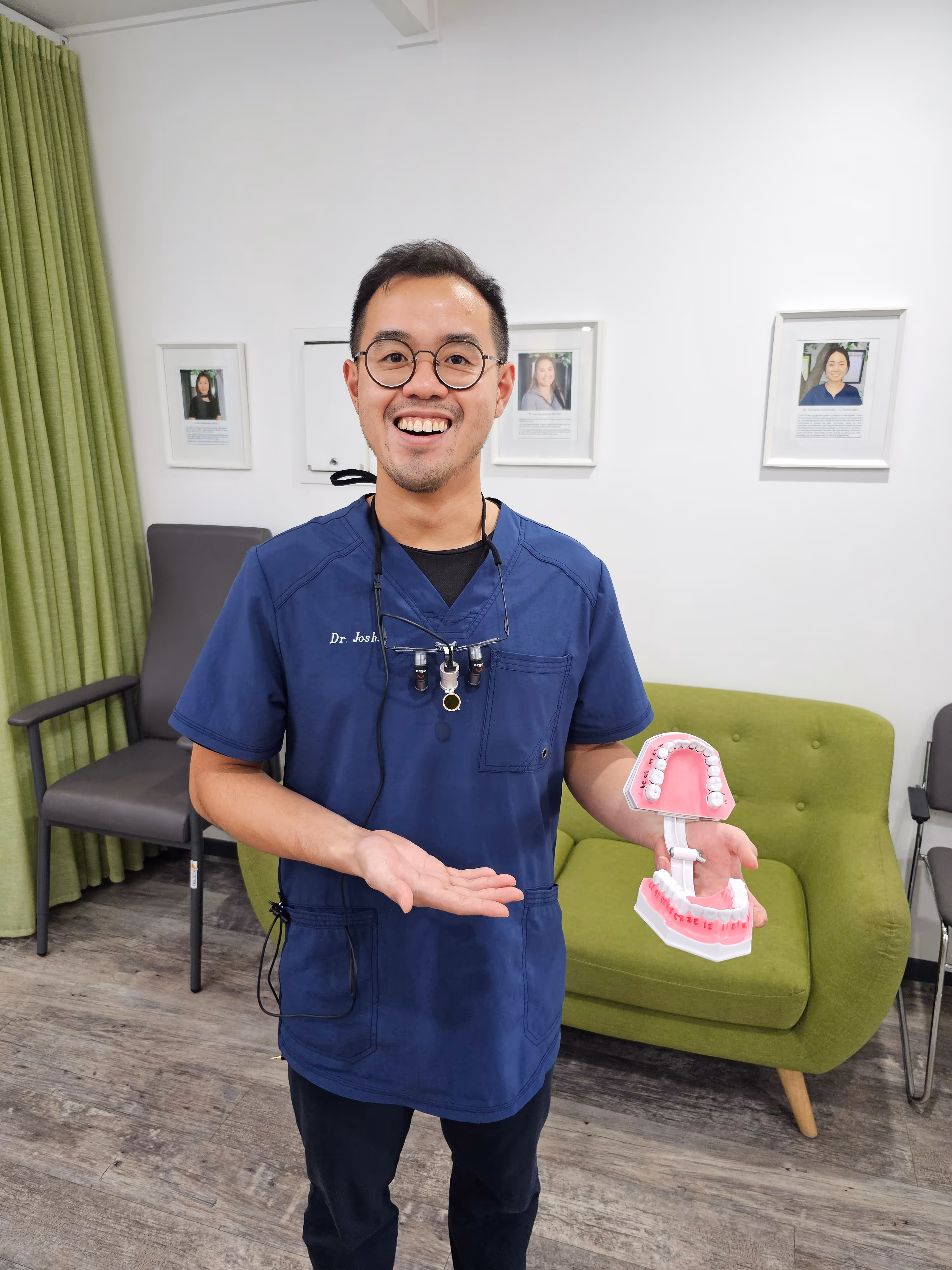 A dentist holding a teeth diagram