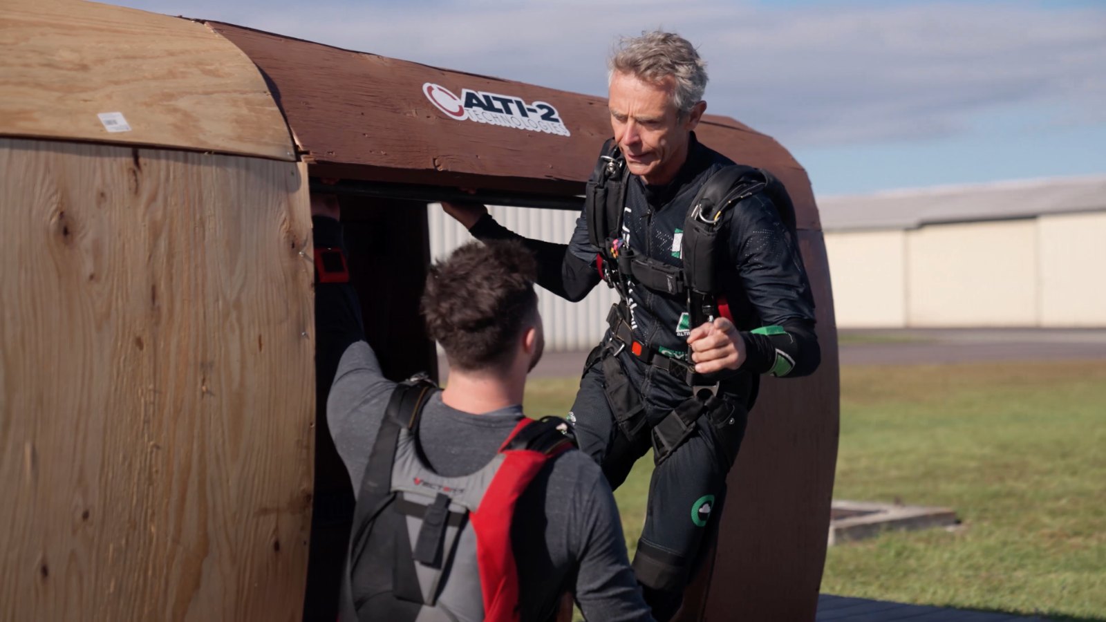 Coach briefing a jumper at the mock-up door