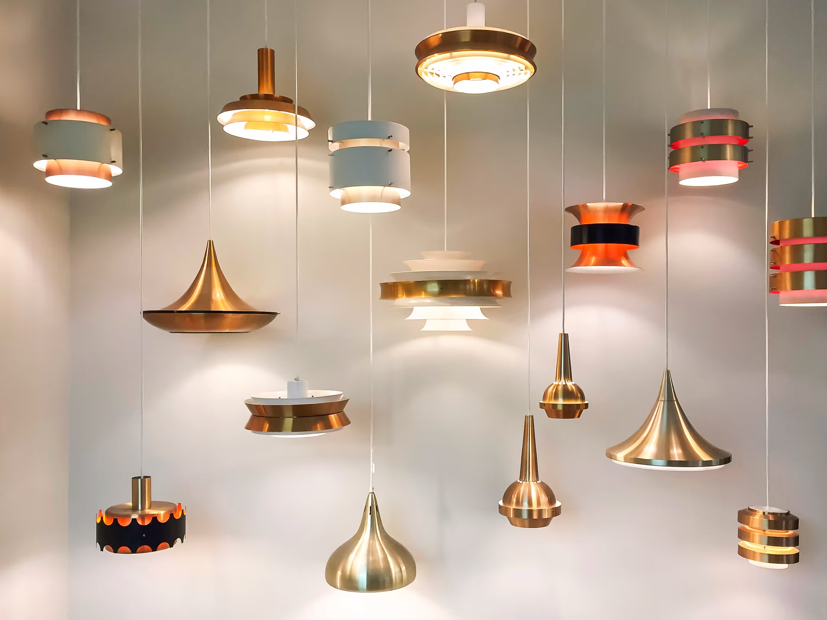 Wall of different kinds of hanging lights with its lights turned on
