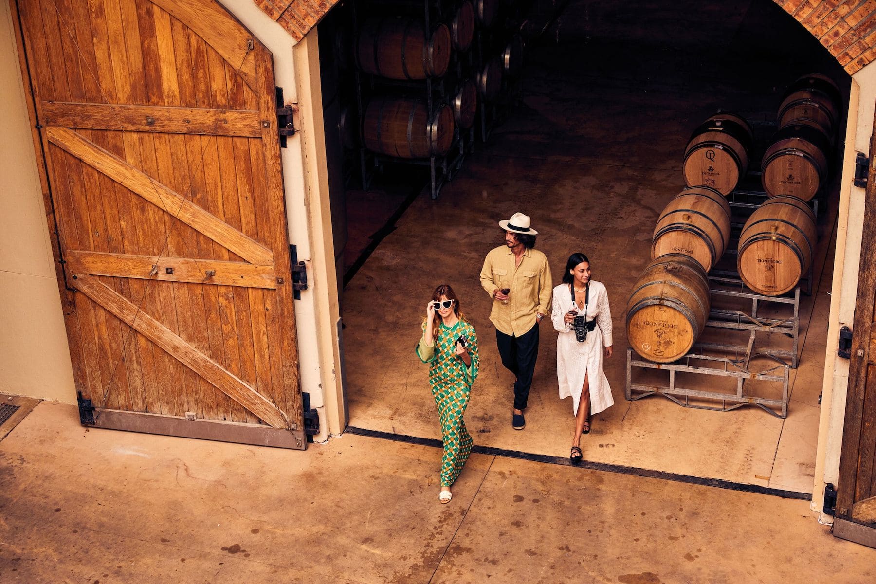 Guests walking through a wine cellar