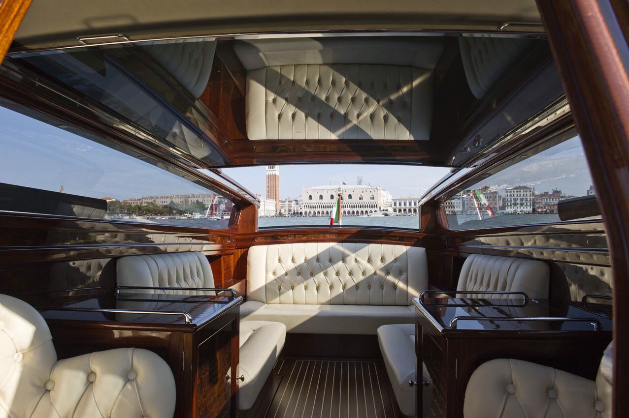 A privately chartered luxury limousine boat navigating the Canals of, Venice