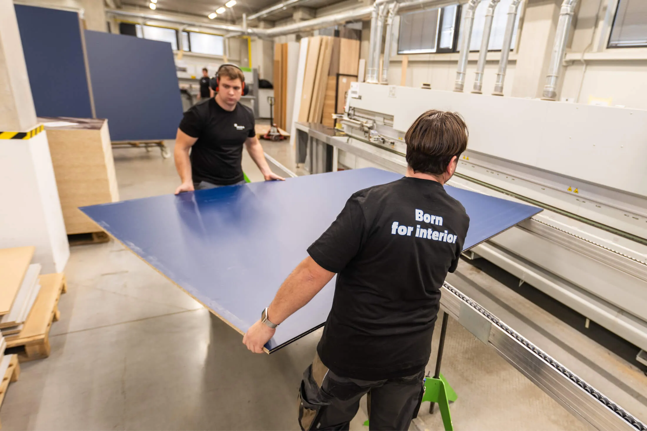 A two workers carrying a desk