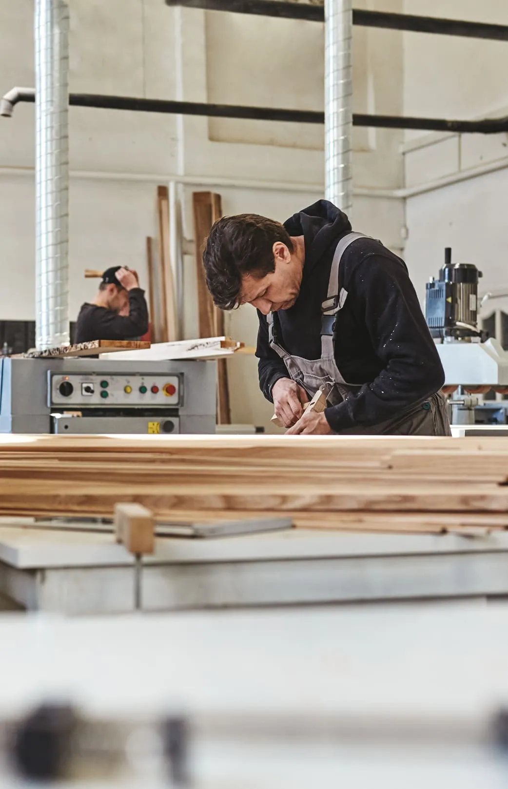 A person working with wood in warehouse