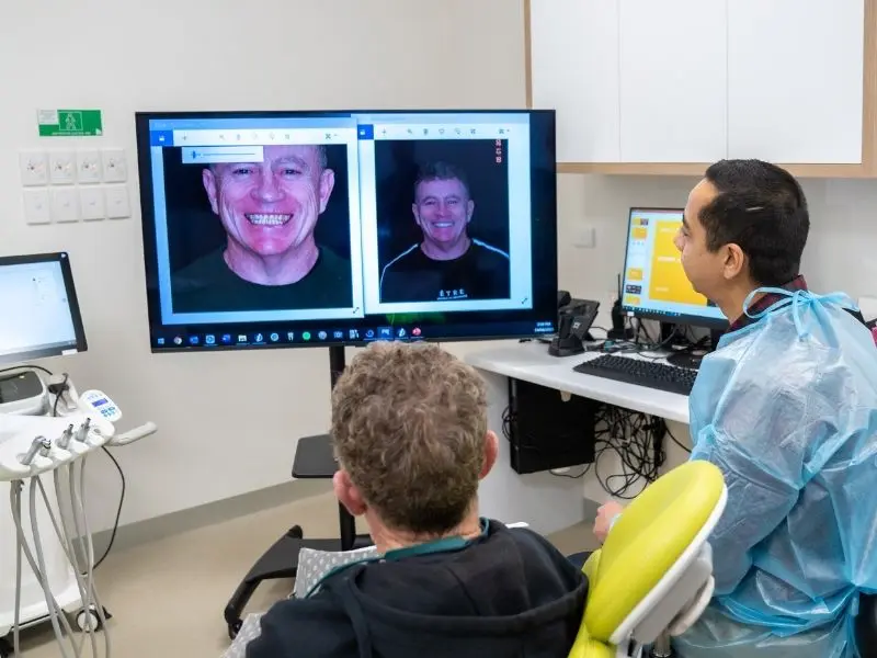 Dr Amit discusses the all-on-4 dental implants treatment and reviews with a patient at Great Alpine Dental.