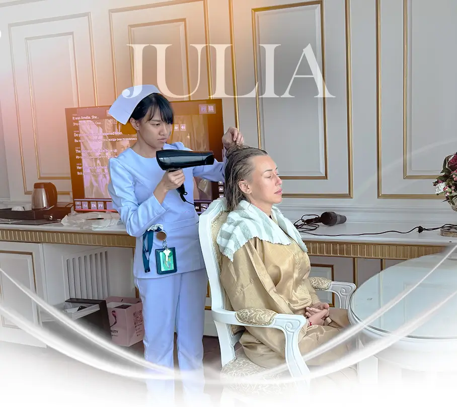 Nurse blow dry a patients hair.