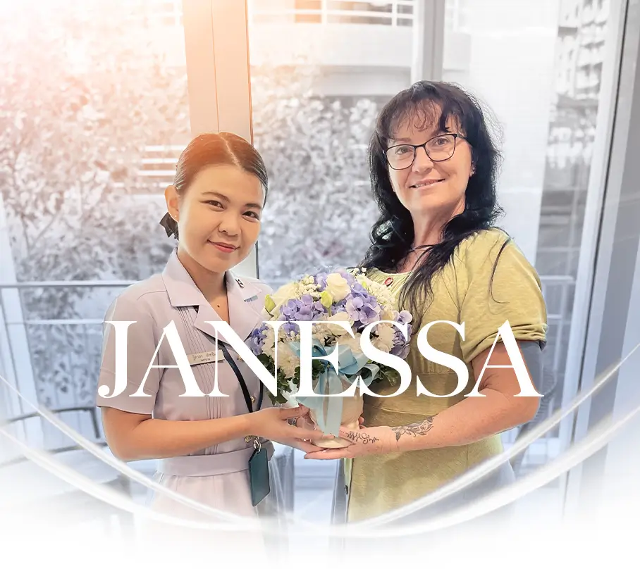Nurse and patient smiling together while holding a flower bouquet.