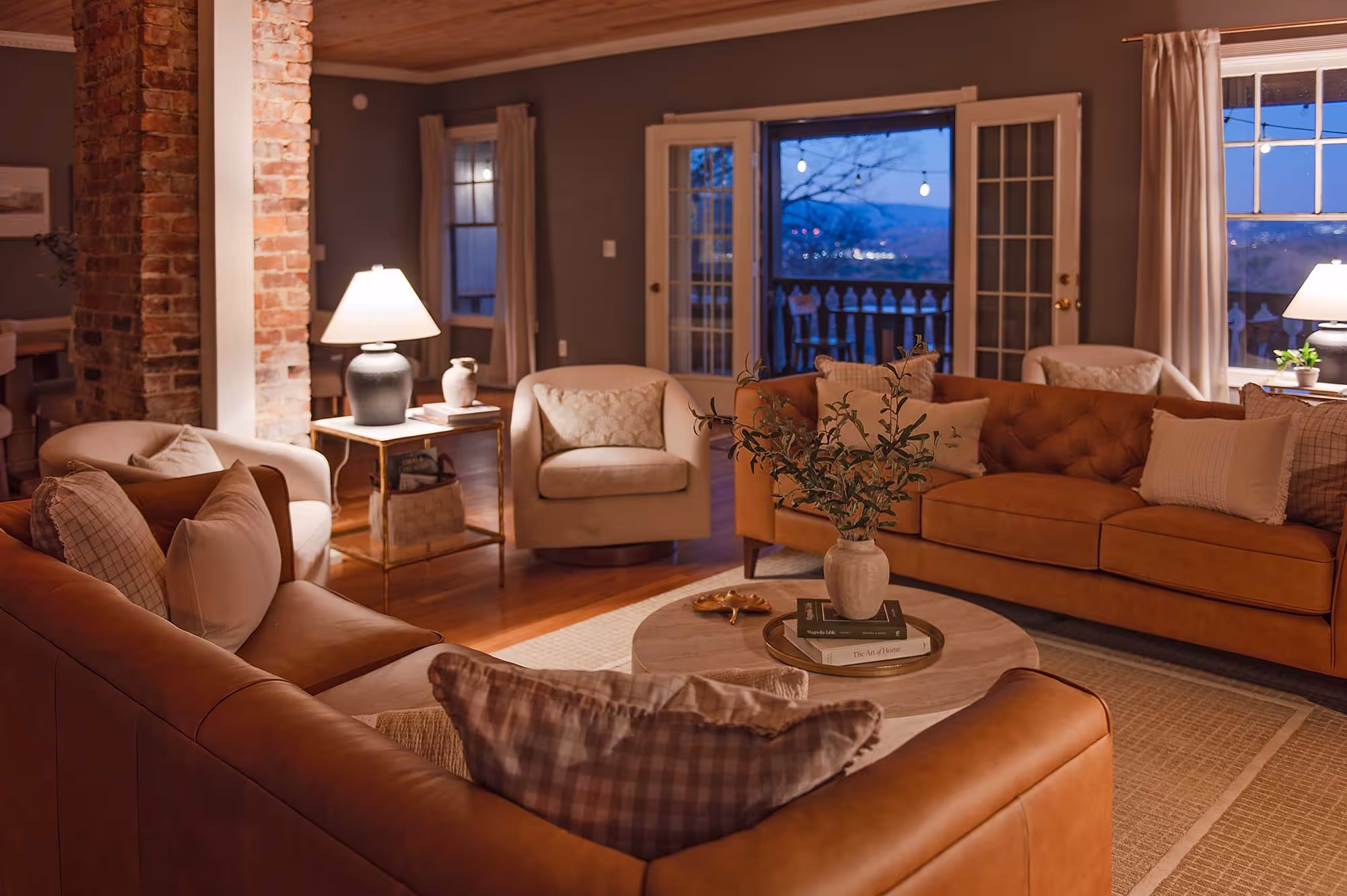 Cozy group of couches under lamp light at dusk