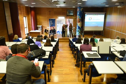 BGI team energetically celebrating at an event, with everyone jumping and smiling in a display of joy and camaraderie