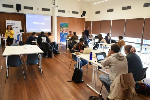 BGI team energetically celebrating at an event, with everyone jumping and smiling in a display of joy and camaraderie