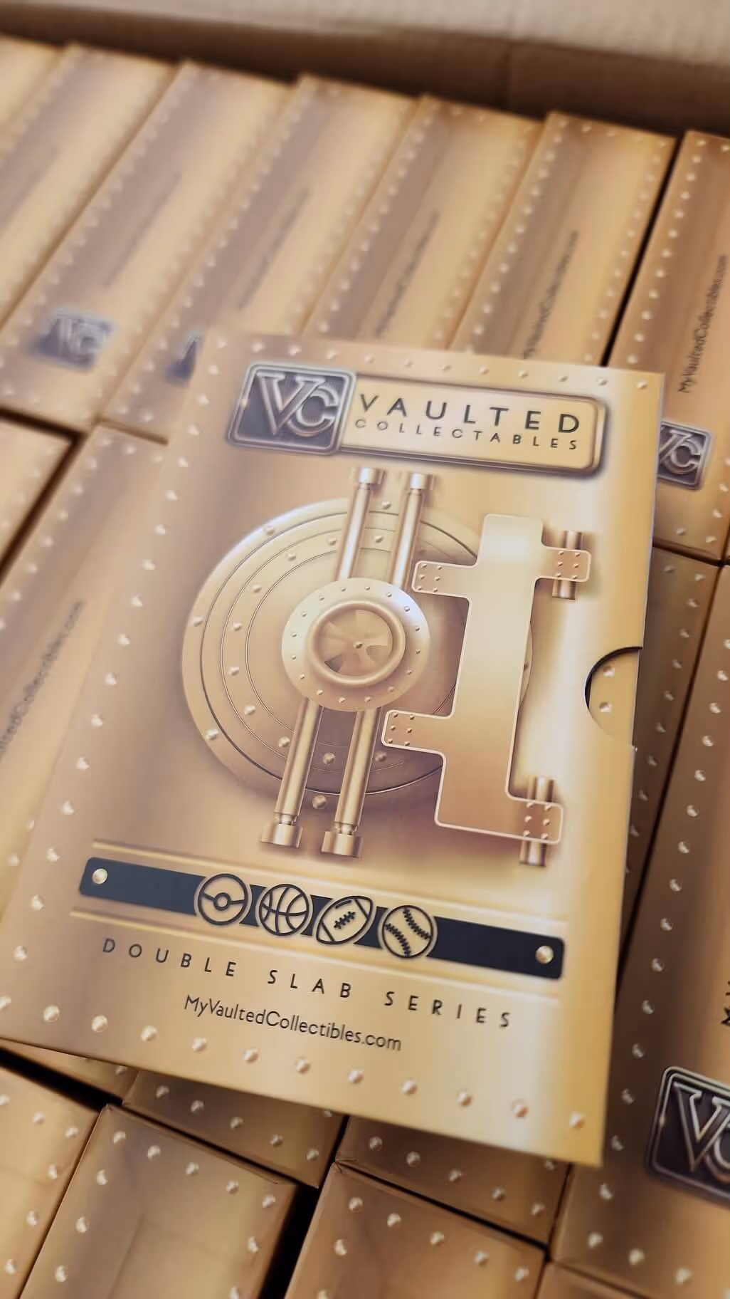 Stacked boxes of Vaulted Collectables Double Slab Series with a vault door design on the cover.