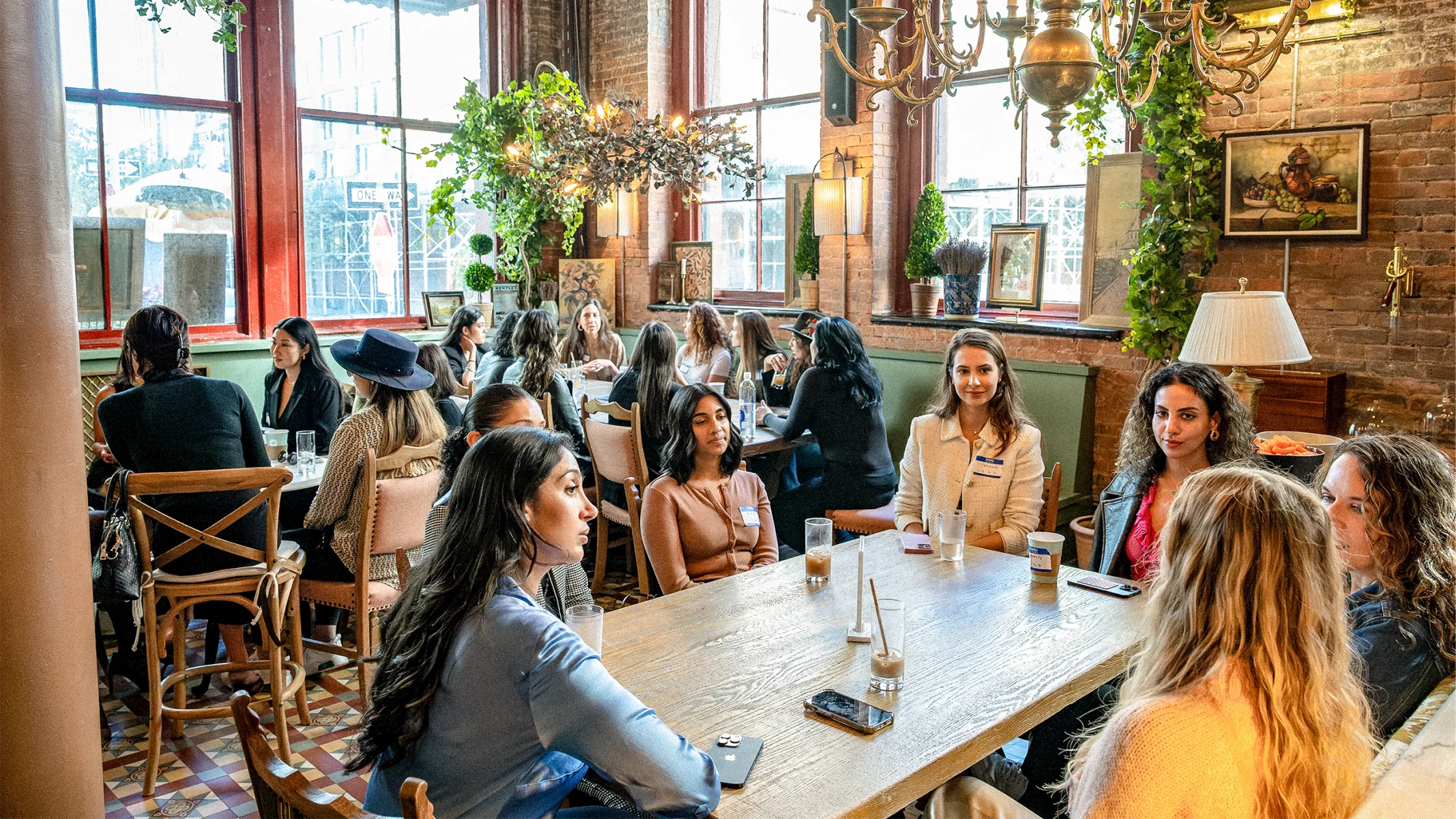 Ash Grewel speaking to women at a table.