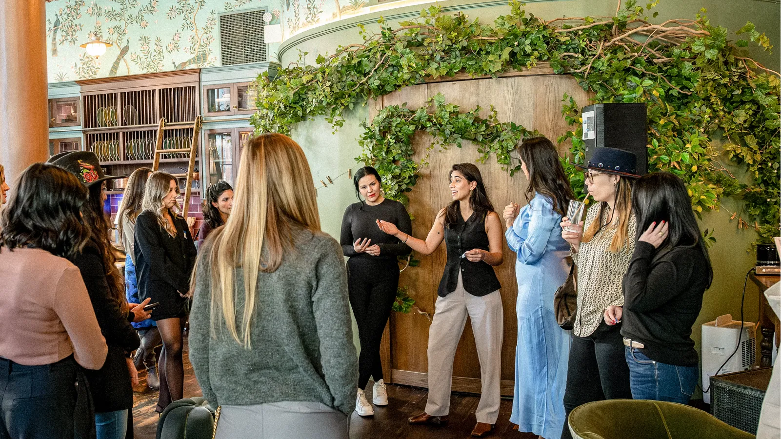 Ash Grewel with another speaker speaking to a group of women.