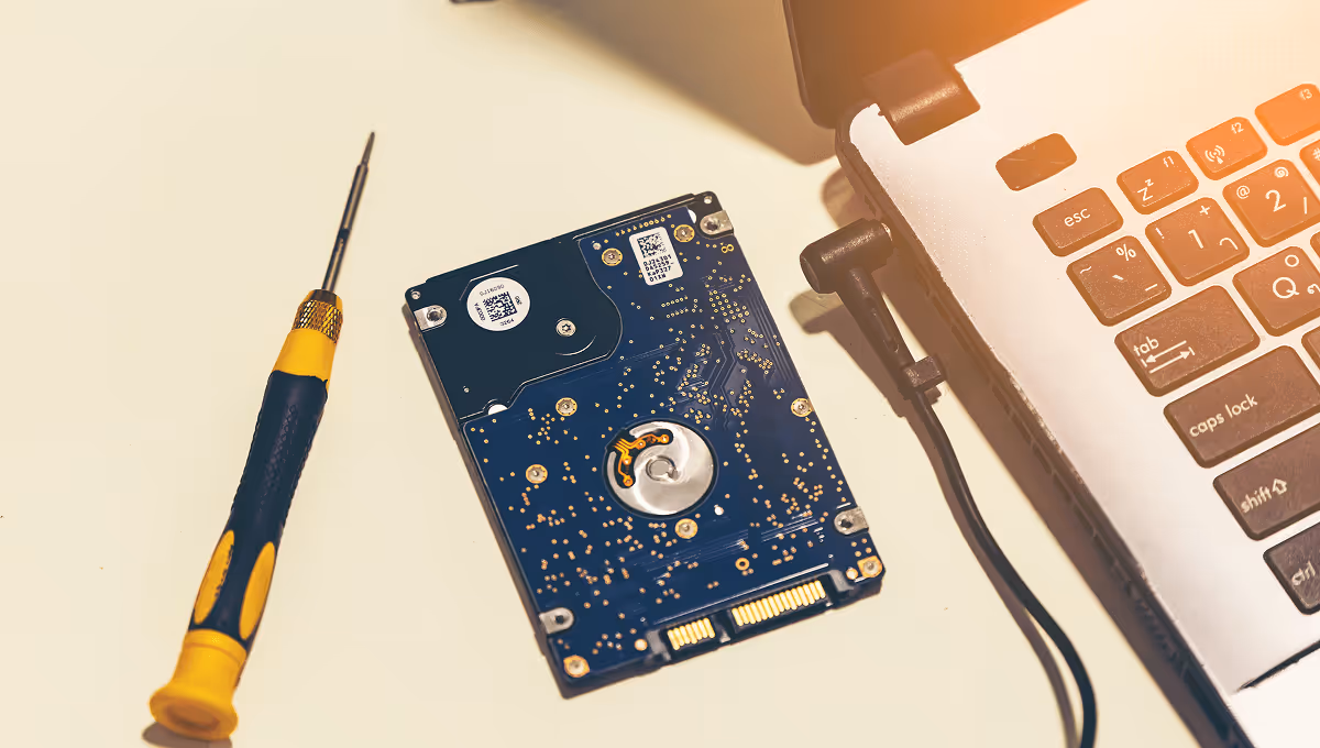 Expert laptop hard drive repair with screwdriver, reliable IT services in Luxembourg for data recovery and hardware maintenance.