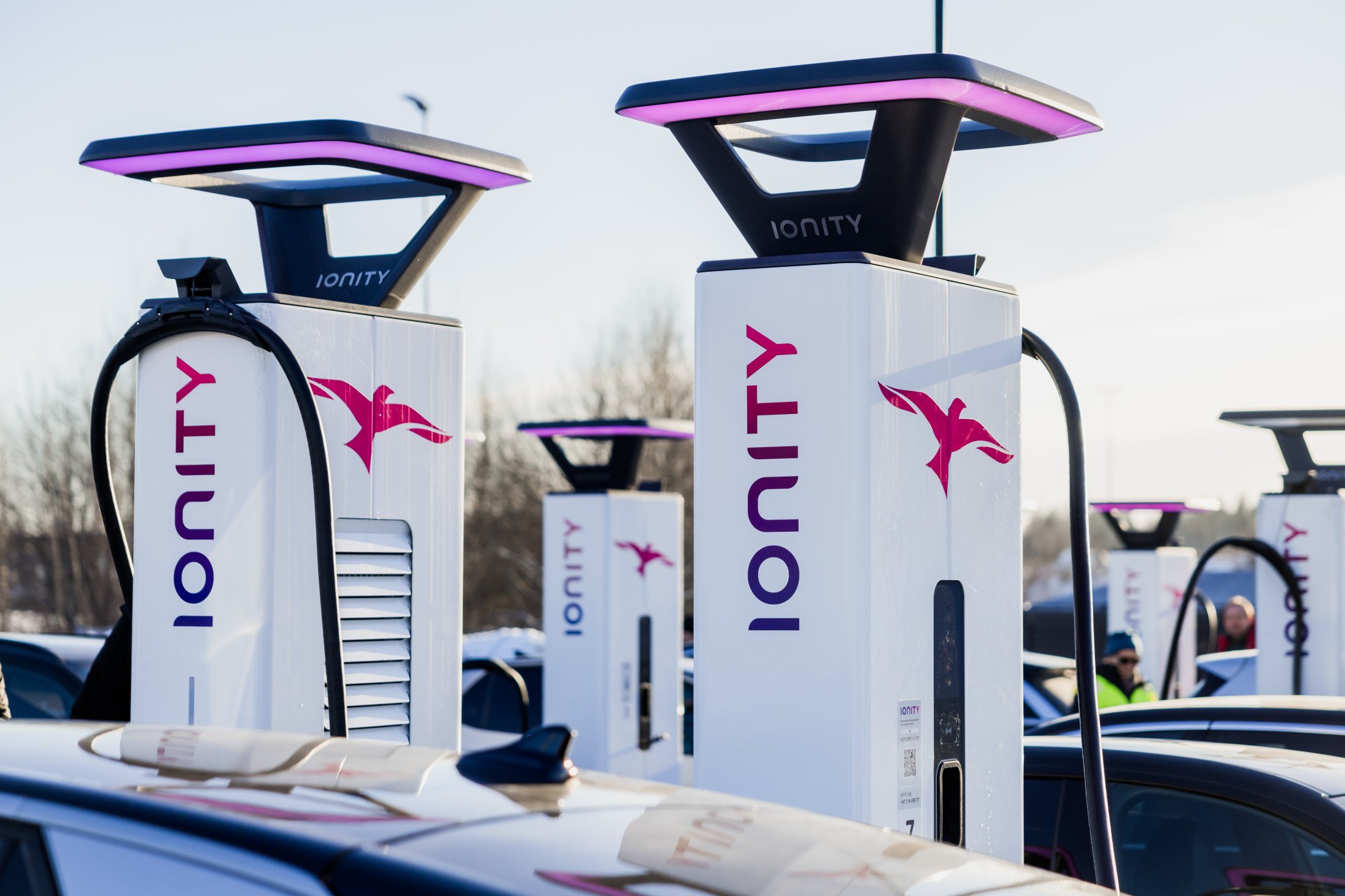 Two IONITY charging stations in warm sunlight