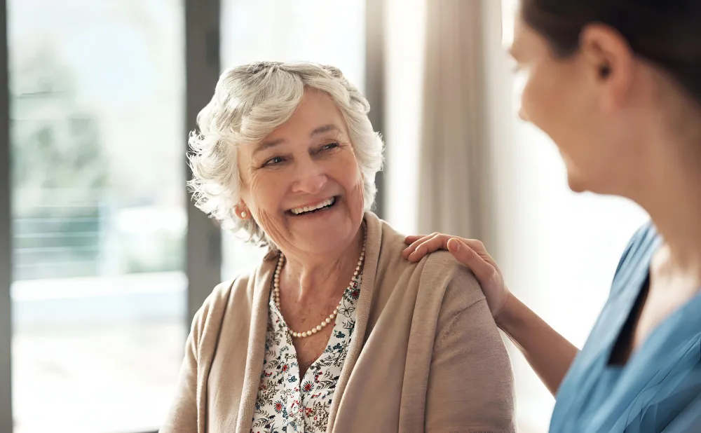 Shot of a happy senior woman being cared for by a young nurse.