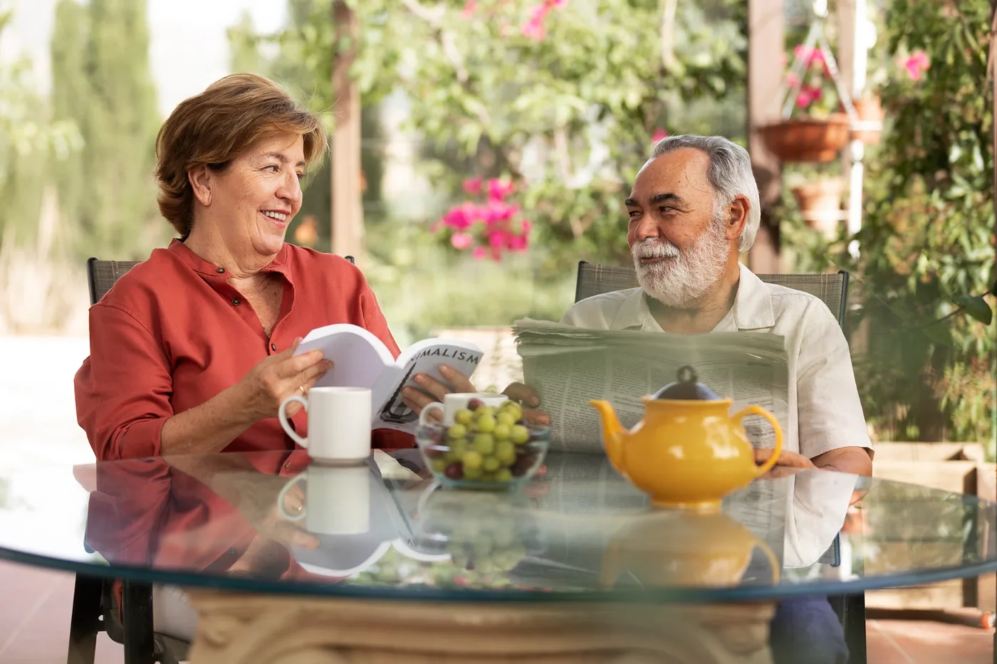 Senior couple reading and enjoying tea together on their patio in Yolo County