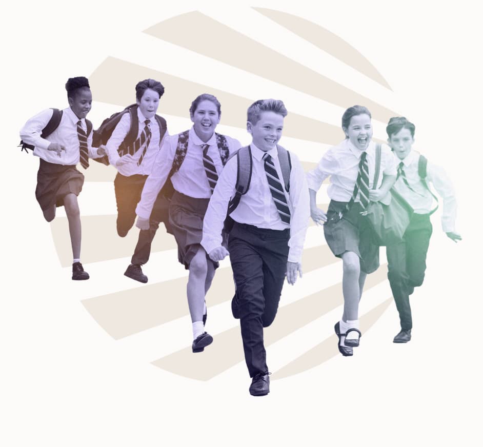 Happy school children running through the playground