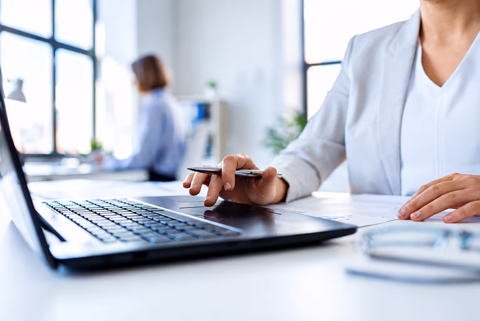 women working at her desk on a laptop