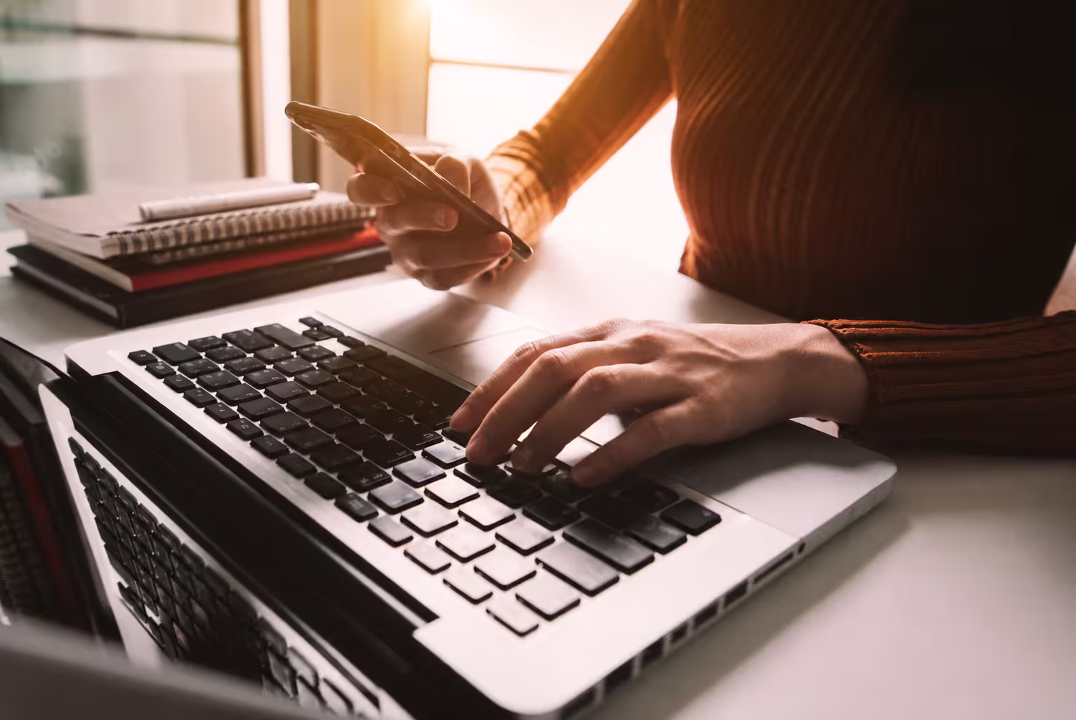 woman sitting at her desk working on her laptop