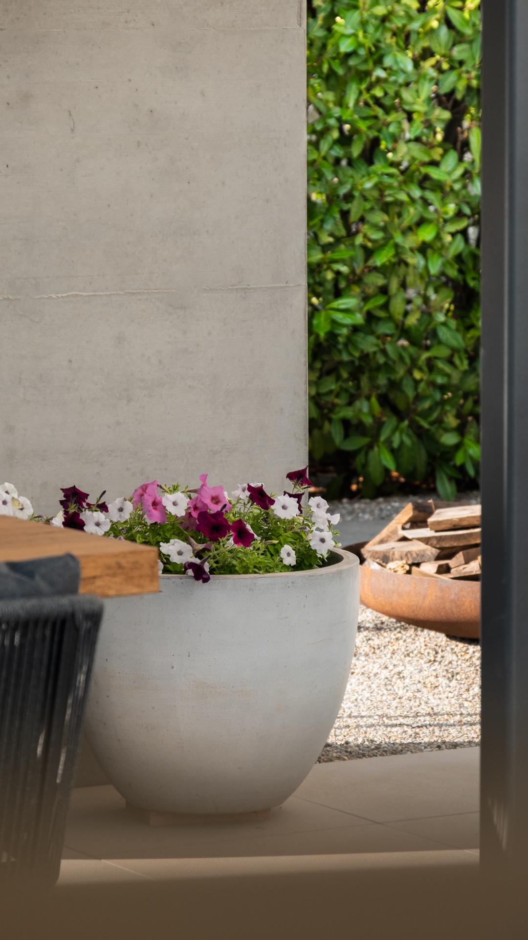 Beton Loggia mit Betontopf und farbigen Blumen. 
