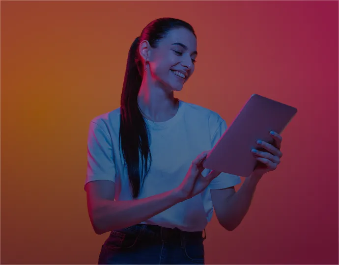 A woman holding a tablet computer surrounded by a bold neon red-pink background.