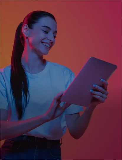 A woman holding a tablet computer surrounded by a bold neon red-pink background.