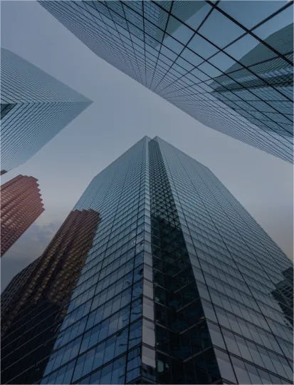 Modern, business skyscrapers with shiny glass windows, seen from below.