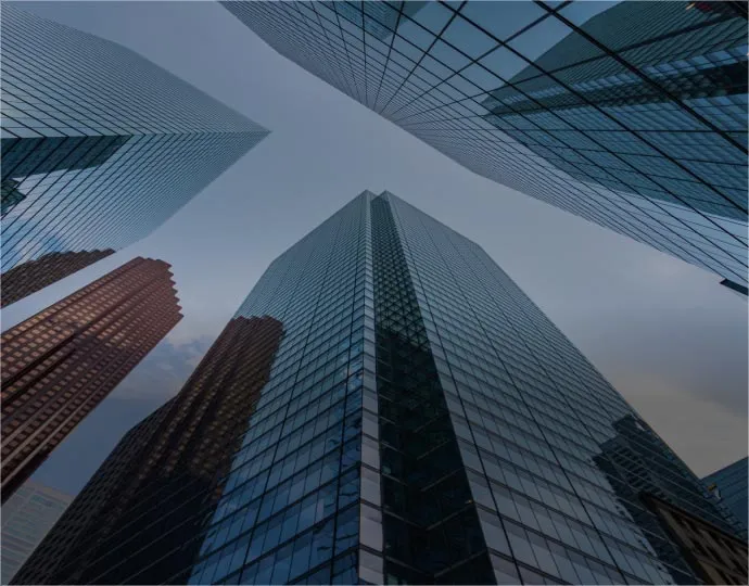 Modern, business skyscrapers with shiny glass windows, seen from below. 