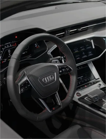 Interior view of an Audi car showcasing modern features of the dashboard and seating.