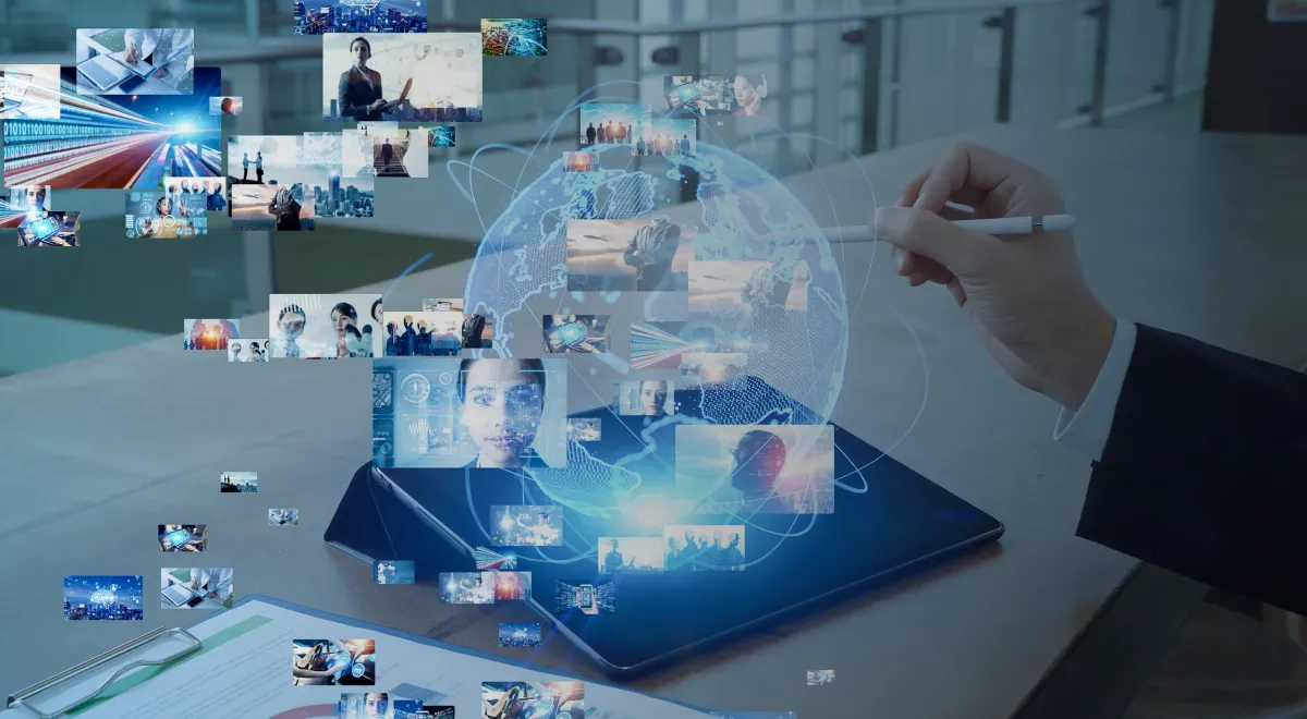 A businessman interacts with a tablet displaying a world map and media images.