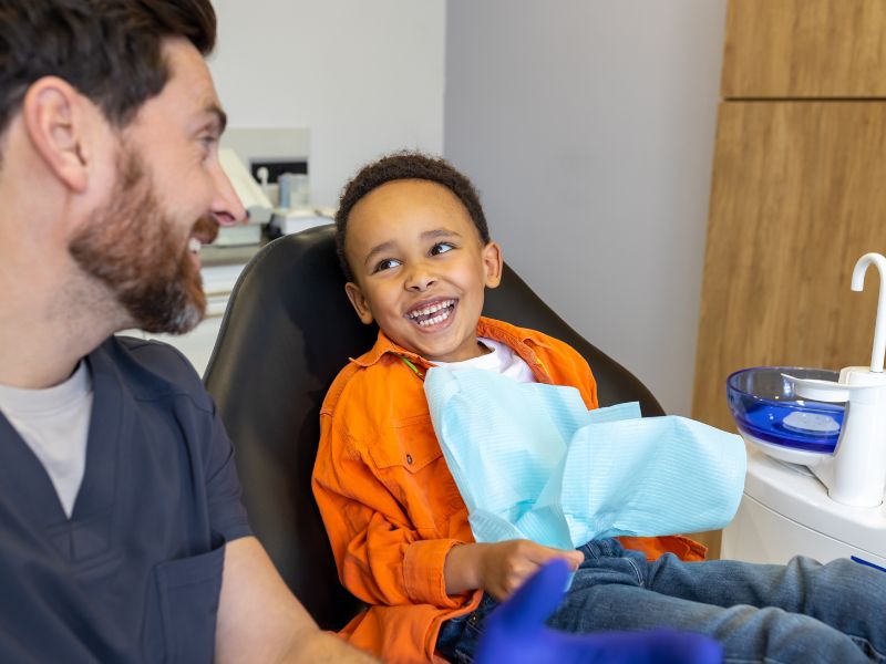 Smiling child talking with his orthodontist during a consultation in Jacksonville
