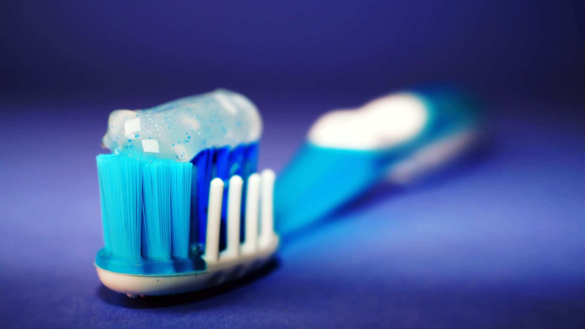 Close-up of a soft-bristled toothbrush with toothpaste on the bristles