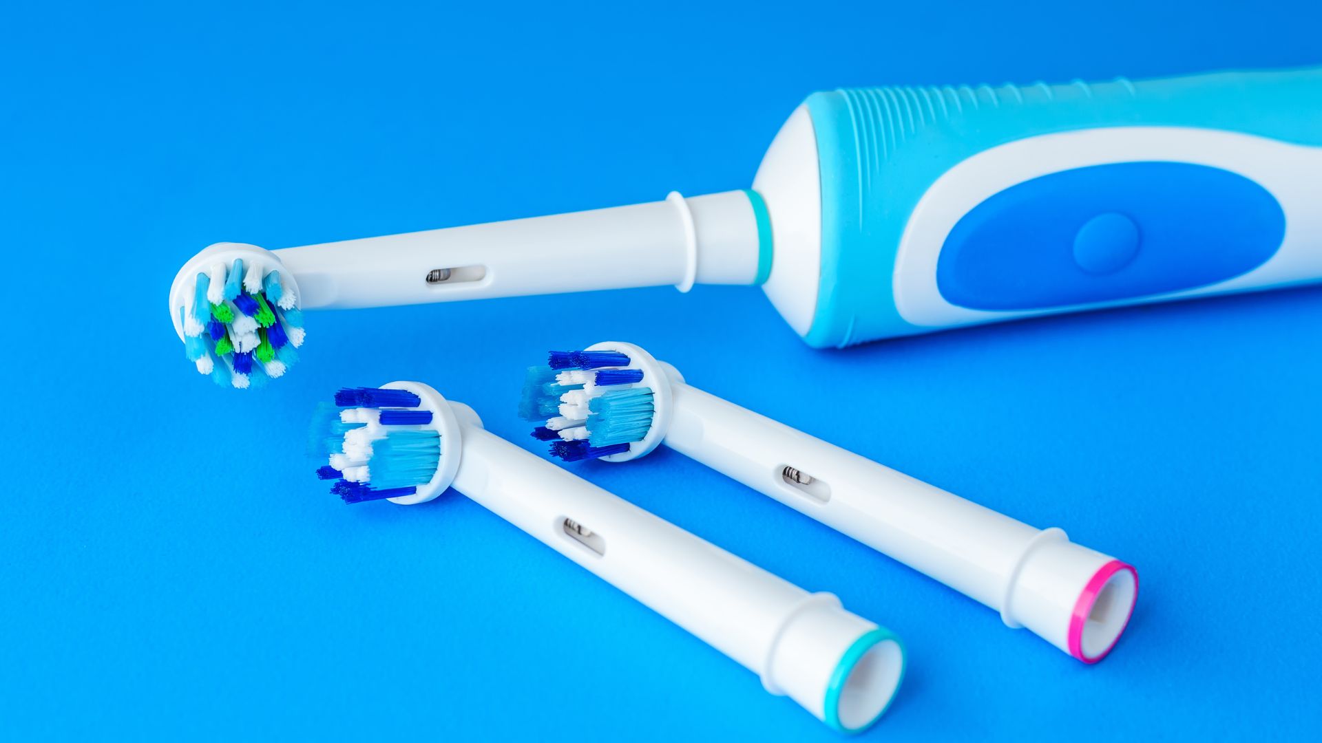 Electric toothbrush with three extra replacement brush heads
