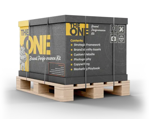 Large black and yellow box labeled 'THE ONE Brand Performance Kit' on a wooden pallet, listing contents such as Strategic Framework, Brand Identity Assets, Custom Website, Photography, Copywriting, and Marketing Playbook.