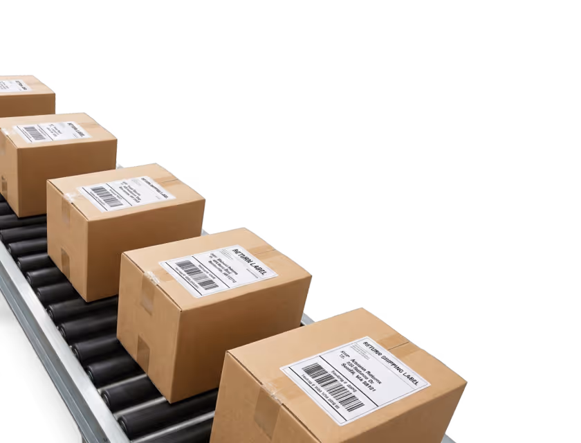 Cardboard boxes with shipping labels on a conveyor belt in a warehouse or shipping facility.