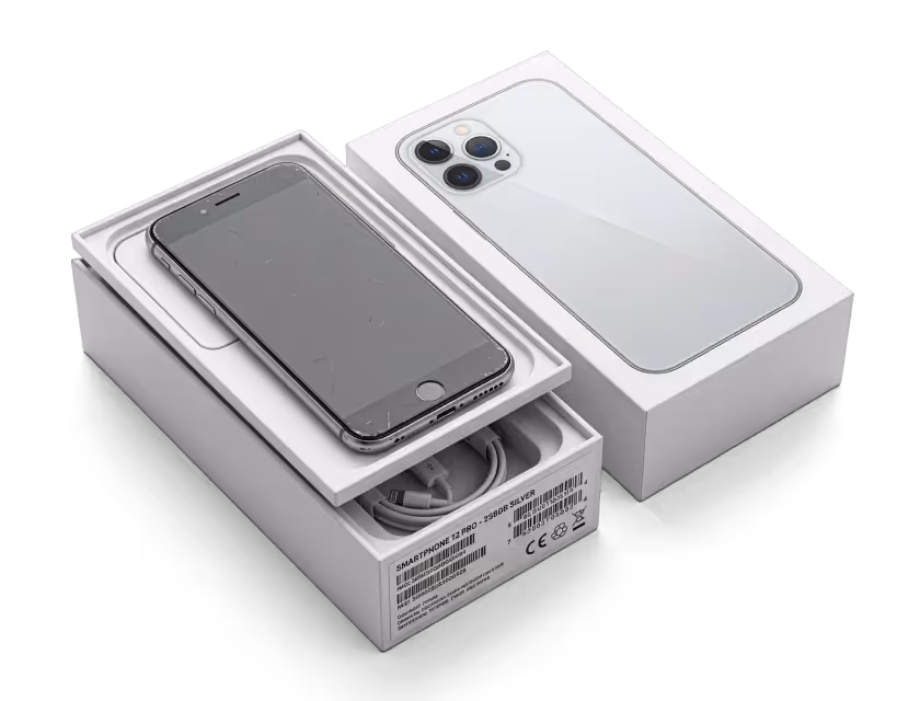 Silver smartphone with a black screen placed in an open white box next to its lid showing a rear camera design.