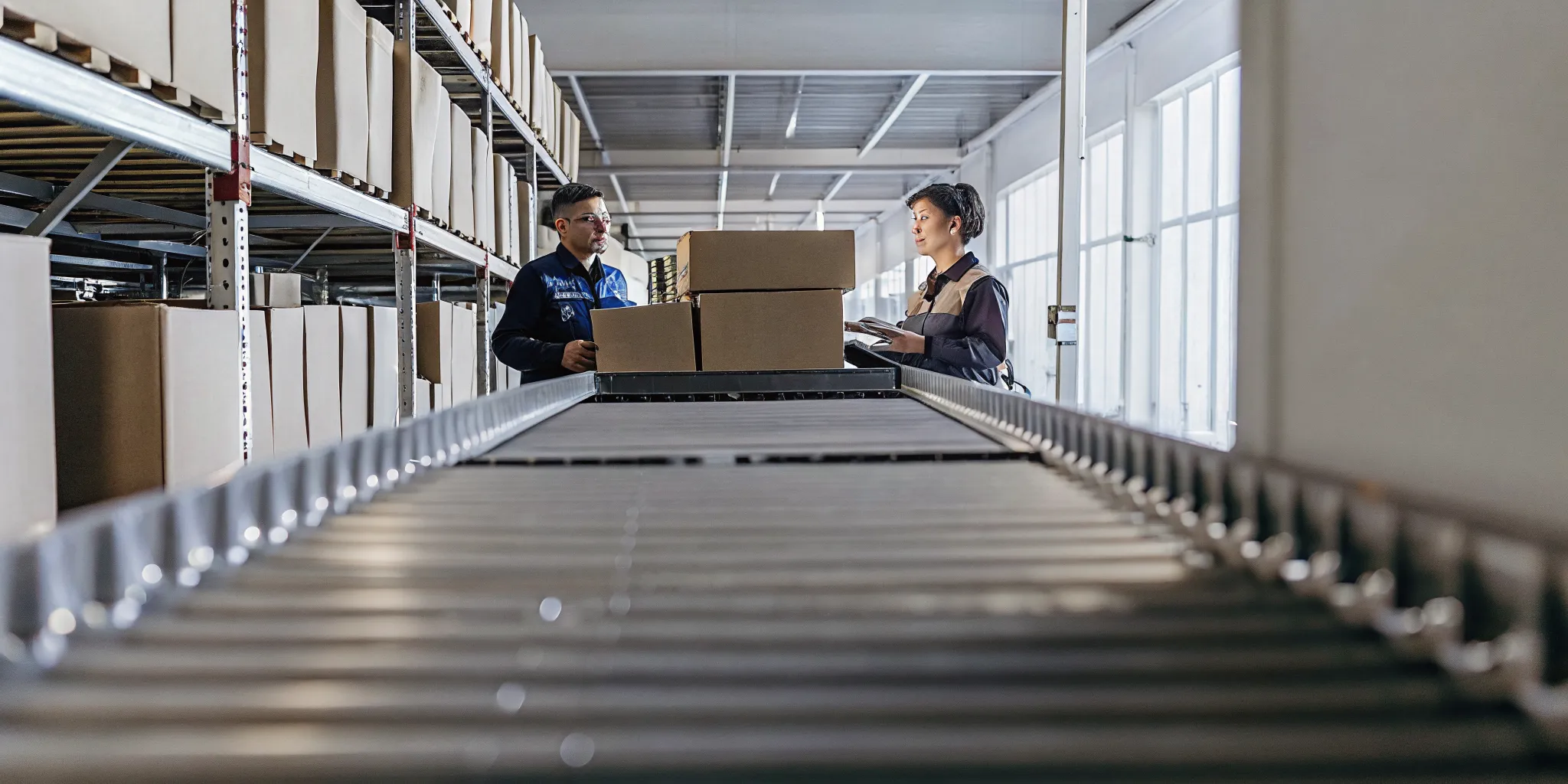 Warehouse sorting line for returned products being inspected by operations team