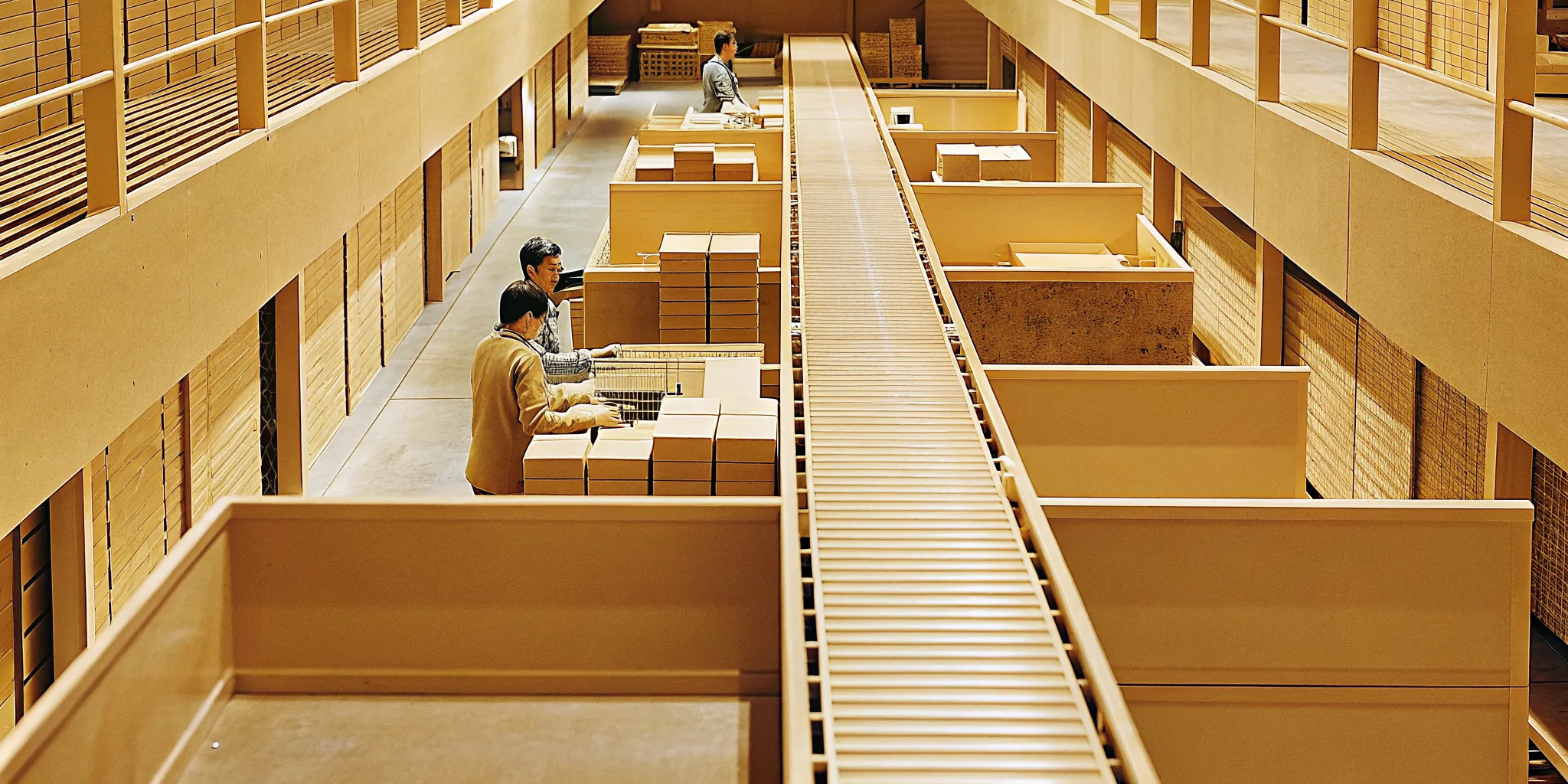 Modern returns processing center interior with conveyor belts and inspection stations for reverse logistics